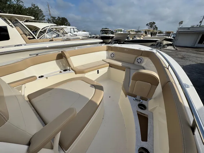  Yacht Photos Pics 2025 Scout 240 XSF boat interior with beige seating and cup holders.