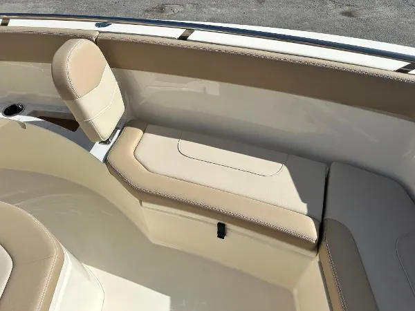  Yacht Photos Pics 2025 Scout 240 XSF boat interior with beige seating and storage.