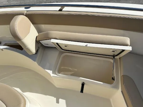  Yacht Photos Pics 2025 Scout 240 XSF boat interior with open storage compartment and beige seating.