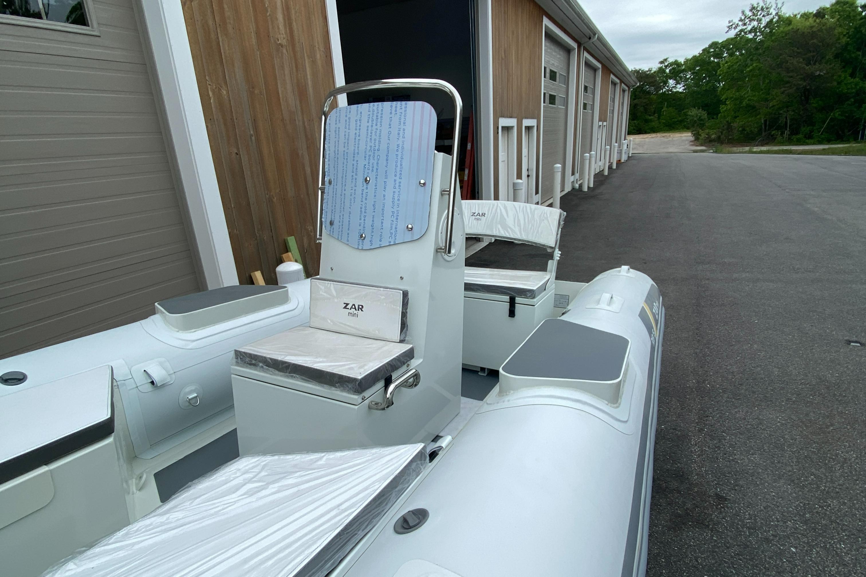 2022 ZAR Mini RIB 15 HDL Tender 60 Hp, docked near storage units.