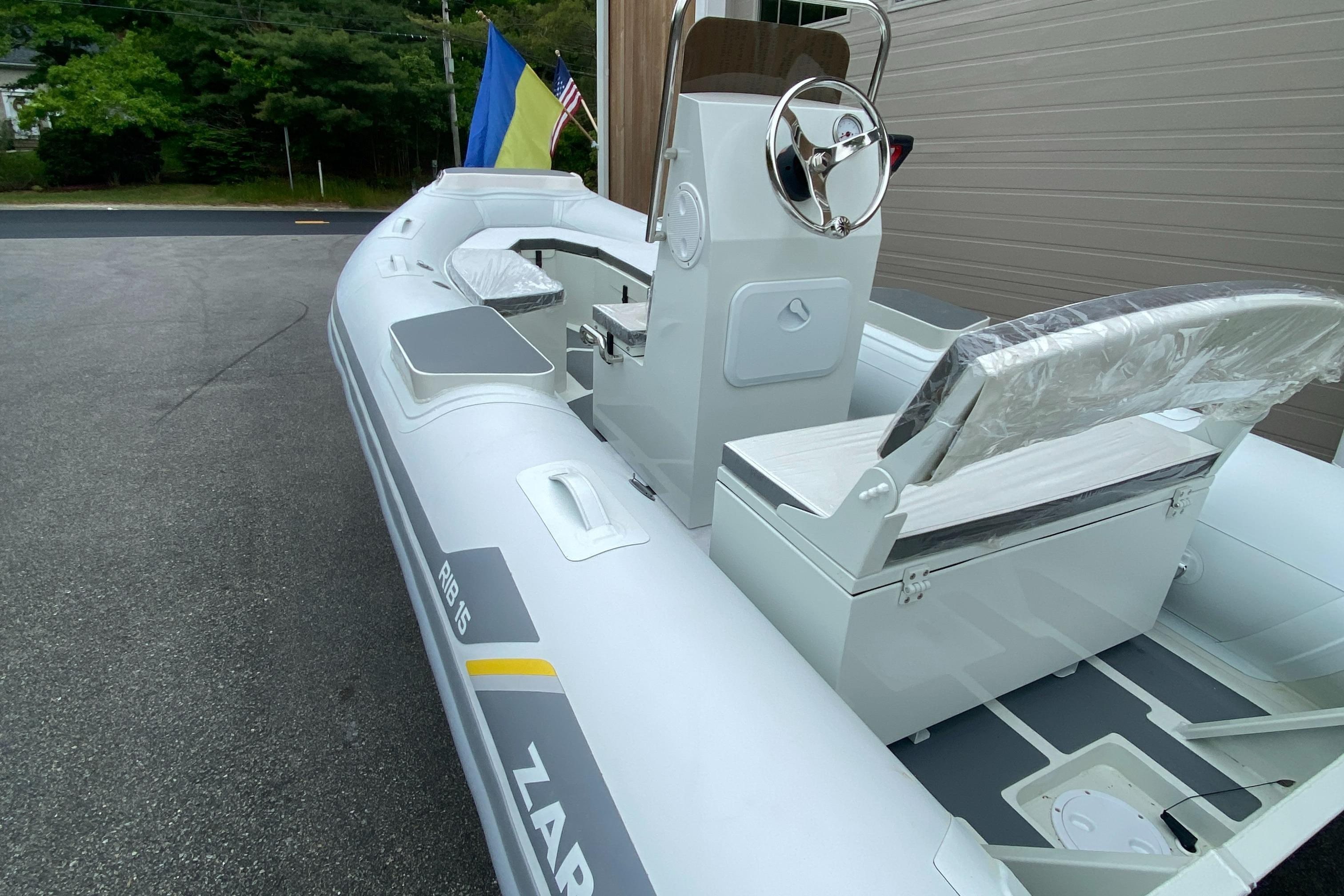 2022 ZAR Mini RIB 15 HDL Tender 60 Hp inflatable boat, docked near a building.