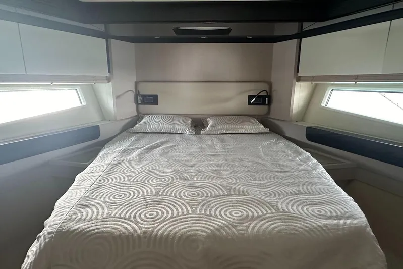  Yacht Photos Pics Luxurious bedroom interior of 2018 Azimut 66 yacht with modern design and cozy bedding.