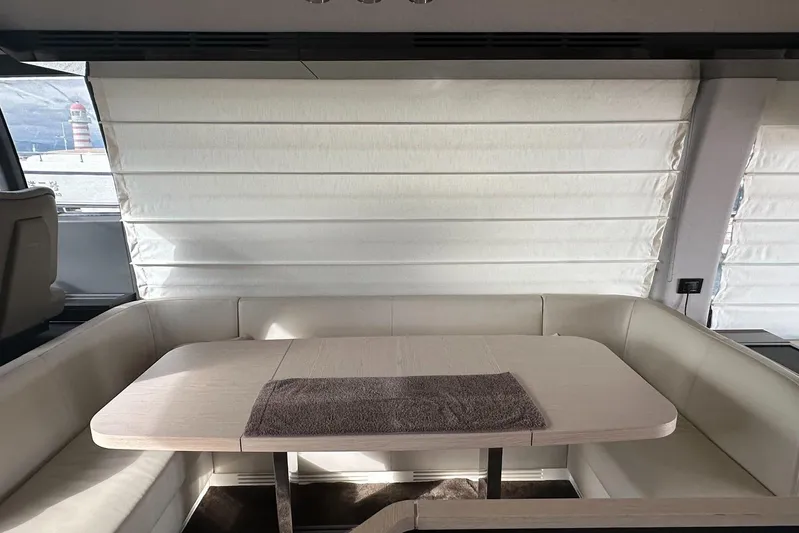  Yacht Photos Pics Luxurious interior of 2018 Azimut 66 yacht with elegant dining area and plush seating.