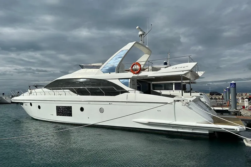  Yacht Photos Pics Luxurious 2018 Azimut 66 yacht docked at marina under cloudy sky.