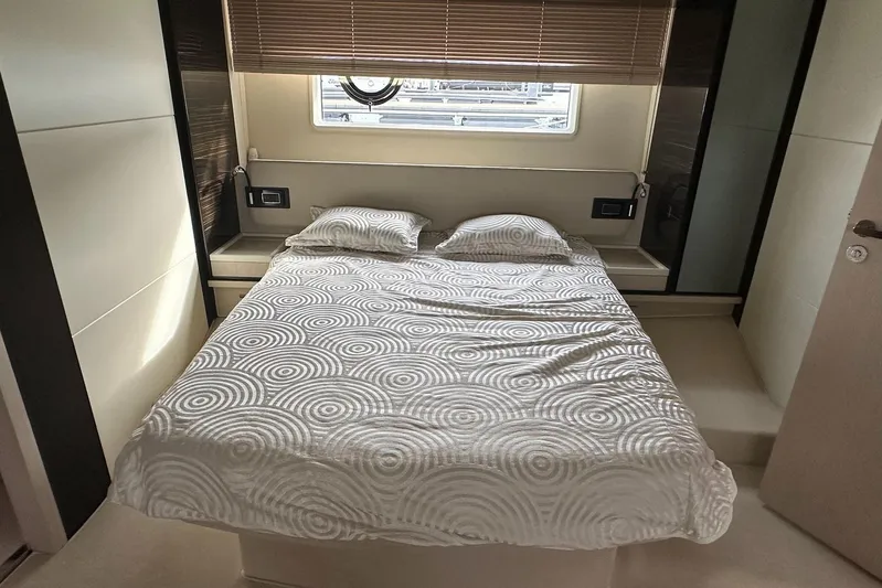  Yacht Photos Pics Luxurious bedroom interior of 2018 Azimut 66 yacht with modern design and cozy bedding.