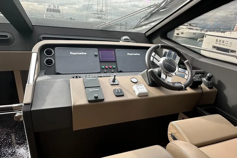  Yacht Photos Pics Cockpit of 2018 Azimut 66 yacht with Raymarine navigation system and modern steering wheel.