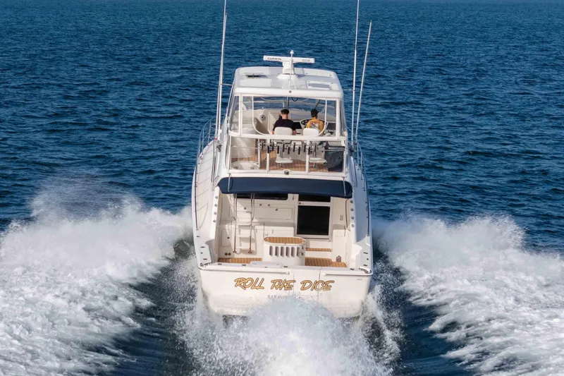 Roll The Dice Yacht Photos Pics 2005 Riviera 47 Convertible yacht cruising on open water.