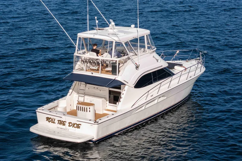 Roll The Dice Yacht Photos Pics 2005 Riviera 47 Convertible yacht cruising on open water.