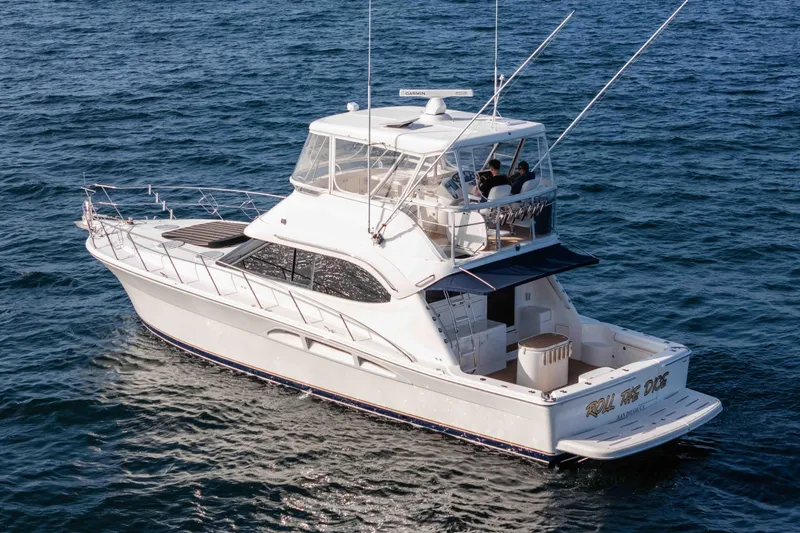 Roll The Dice Yacht Photos Pics 2005 Riviera 47 Convertible yacht cruising on open water.