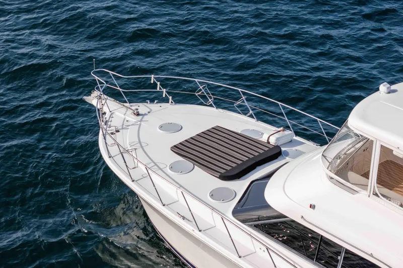 Roll The Dice Yacht Photos Pics 2005 Riviera 47 Convertible yacht on open water, showcasing sleek design and luxury features.