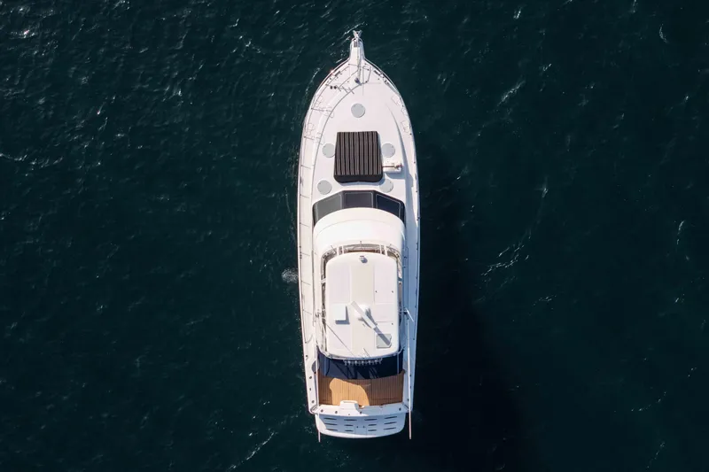 Roll The Dice Yacht Photos Pics Aerial view of 2005 Riviera 47 Convertible yacht on open water.