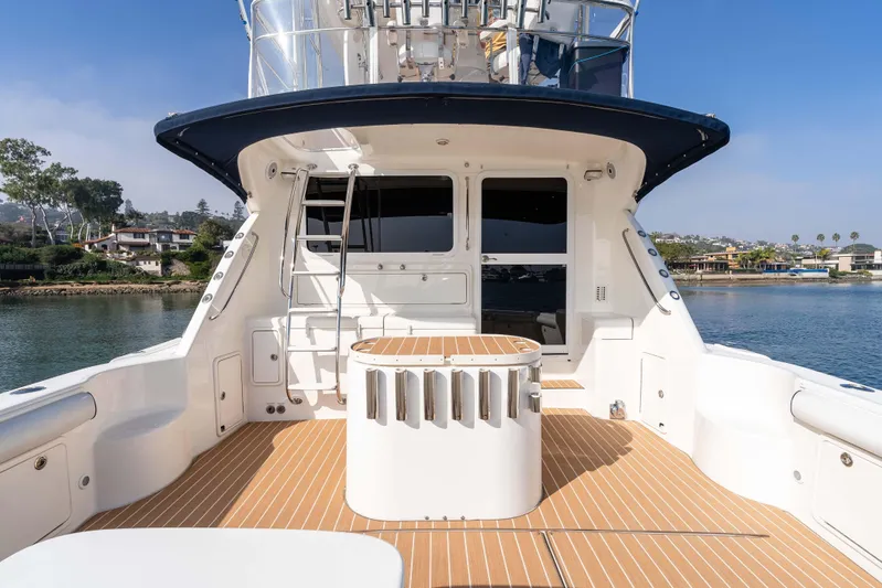 Roll The Dice Yacht Photos Pics 2005 Riviera 47 Convertible yacht deck with scenic waterfront view.