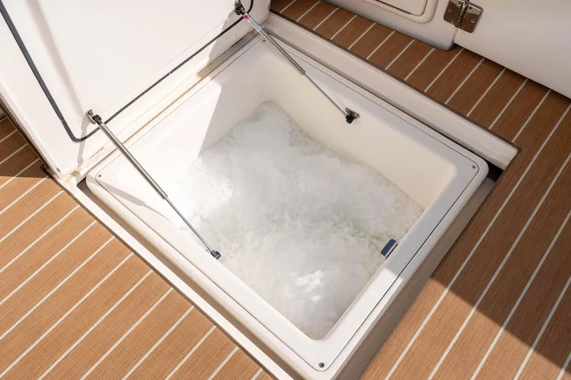 Roll The Dice Yacht Photos Pics Ice-filled storage compartment on 2005 Riviera 47 Convertible yacht deck.