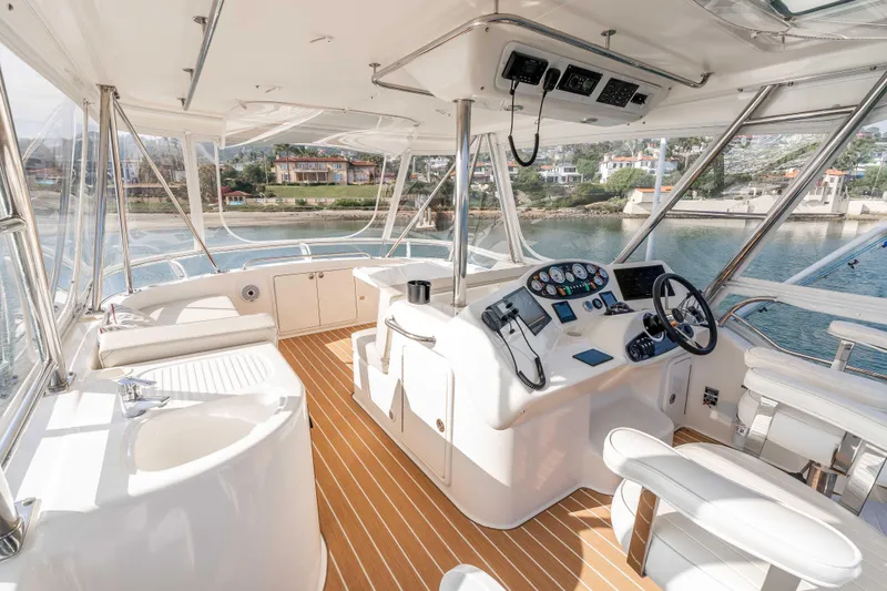 Roll The Dice Yacht Photos Pics Luxurious 2005 Riviera 47 Convertible yacht interior with modern helm and panoramic views.