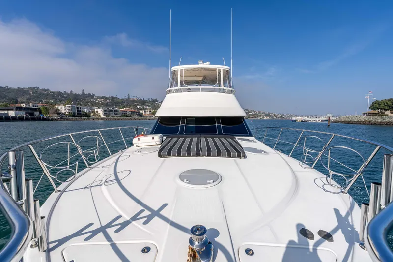 Roll The Dice Yacht Photos Pics 2005 Riviera 47 Convertible yacht on calm waters, showcasing sleek design and luxury features.