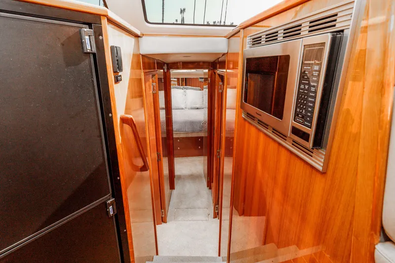 Roll The Dice Yacht Photos Pics Interior of 2005 Riviera 47 Convertible yacht with wood finish and modern appliances.