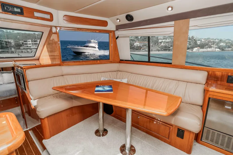 Roll The Dice Yacht Photos Pics Interior of 2005 Riviera 47 Convertible yacht with elegant seating and ocean view.