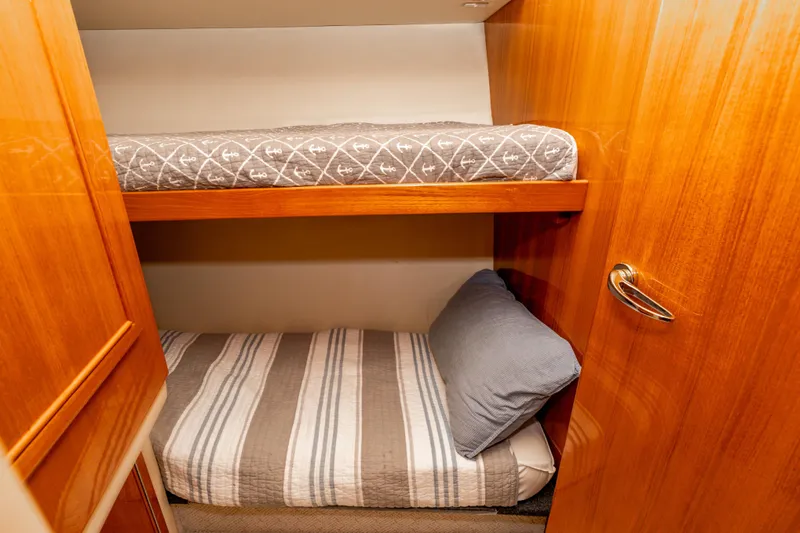 Roll The Dice Yacht Photos Pics Bunk beds in 2005 Riviera 47 Convertible yacht cabin with wooden finish.