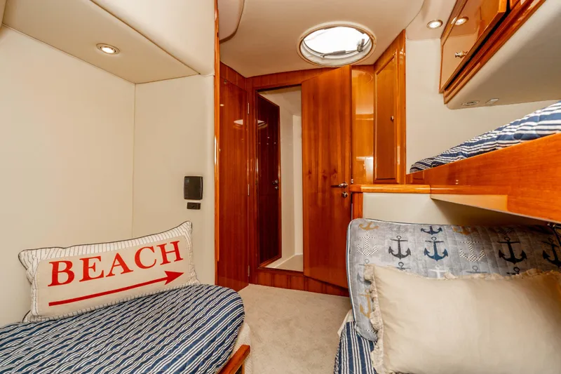 Roll The Dice Yacht Photos Pics 2005 Riviera 47 Convertible yacht cabin with cozy bedding and nautical decor.