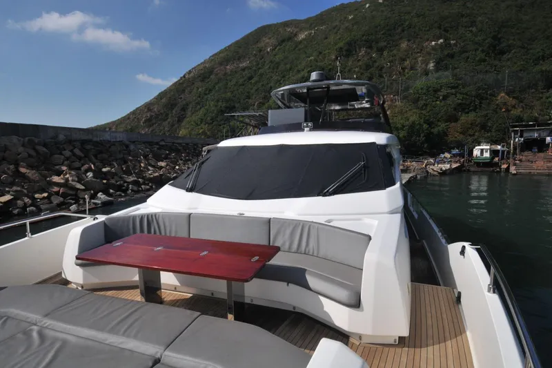  Yacht Photos Pics 2017 Ferretti Yachts 850, luxury yacht docked by rocky shoreline, featuring sleek design.