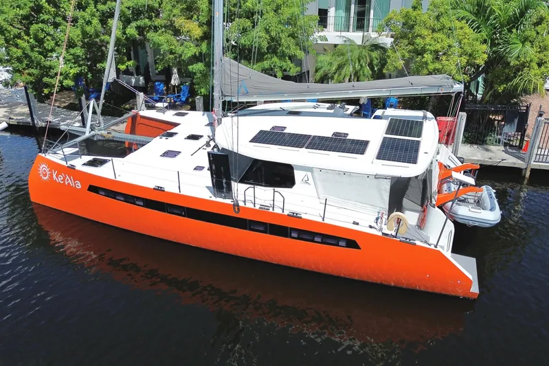 Ke'ala Yacht Photos Pics Orange Balance 482 catamaran docked, featuring solar panels, 2021 model.