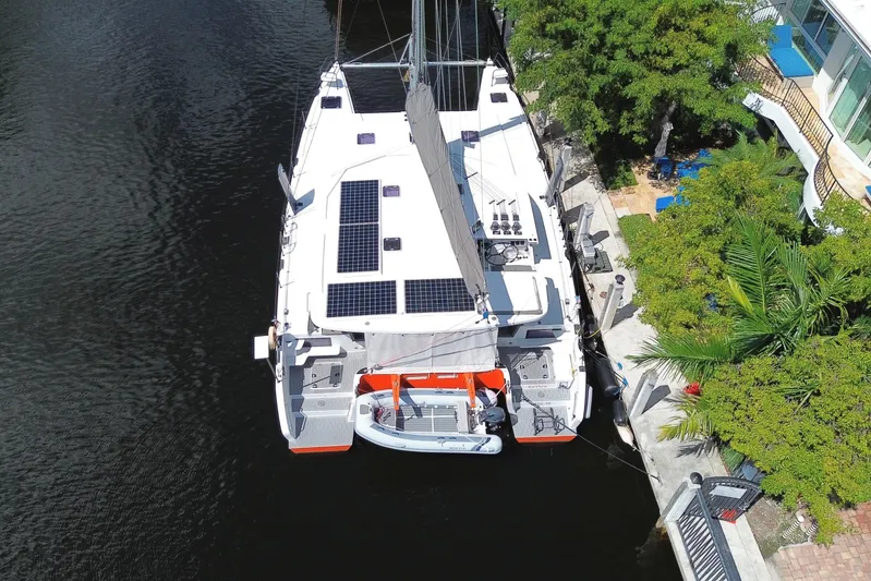 Ke'ala Yacht Photos Pics Aerial view of 2021 Balance 482 catamaran docked, featuring solar panels and lush surroundings.