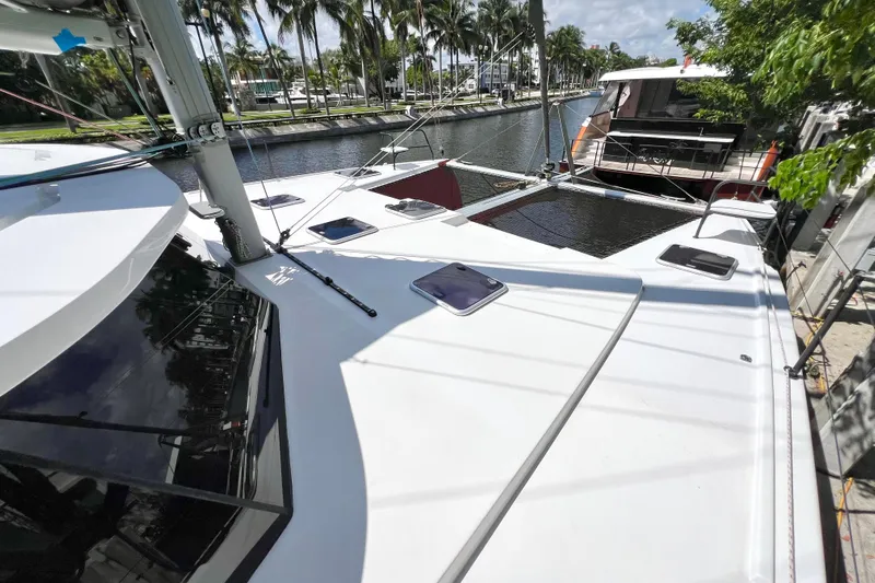 Ke'ala Yacht Photos Pics 2021 Balance 482 catamaran docked by a canal with palm trees.