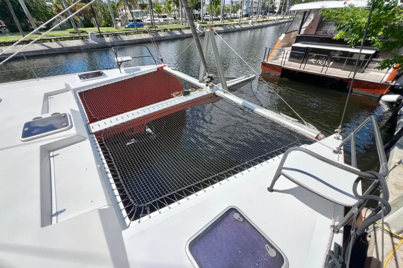 Ke'ala Yacht Photos Pics Catamaran Balance 482, 2021 model, docked with netted deck area and scenic waterfront view.