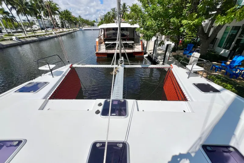 Ke'ala Yacht Photos Pics Catamaran docked in a canal, surrounded by palm trees, Balance 482 model, 2021.