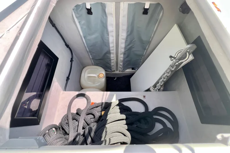 Ke'ala Yacht Photos Pics Interior of a 2021 Balance 482 boat showing storage with rope, chain, and container.