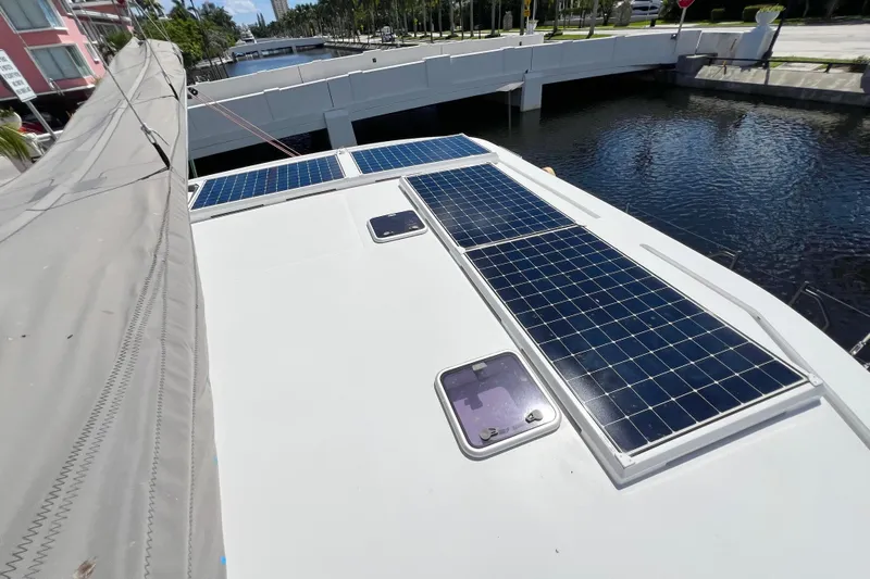 Ke'ala Yacht Photos Pics Catamaran Balance 482 (2021) with solar panels on deck, docked near a bridge.