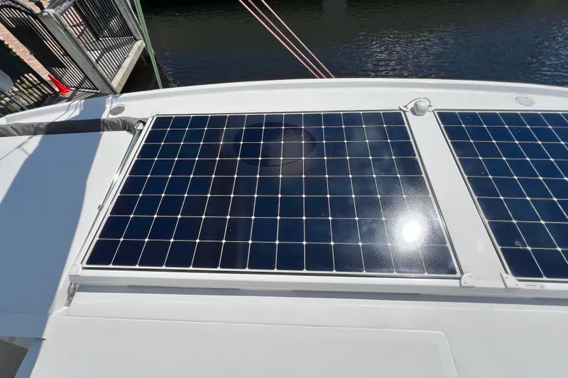Ke'ala Yacht Photos Pics Solar panels on Balance 482 yacht, 2021 model, reflecting sunlight by the water.