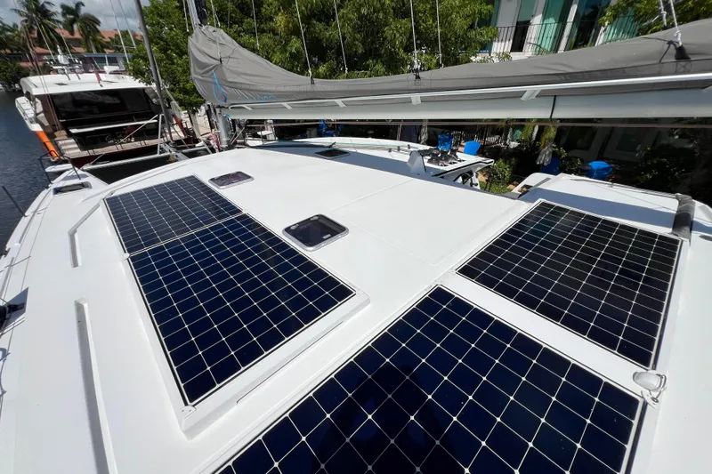 Ke'ala Yacht Photos Pics Sailboat with solar panels on deck, Balance 482 model, 2021, docked near lush greenery.