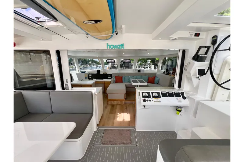 Ke'ala Yacht Photos Pics Interior of 2021 Balance 482 catamaran with modern seating and surfboard decor.
