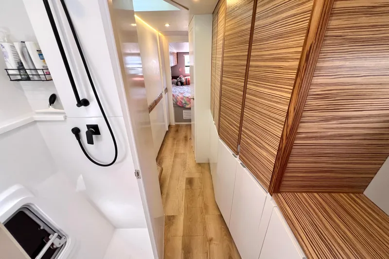 Ke'ala Yacht Photos Pics Modern Balance 482 interior with wood paneling and sleek shower, 2021 model.