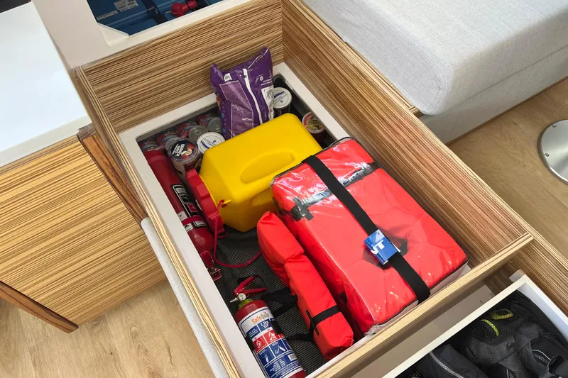 Ke'ala Yacht Photos Pics Storage compartment with safety gear, fire extinguishers, and supplies in a Balance 482, 2021 model.