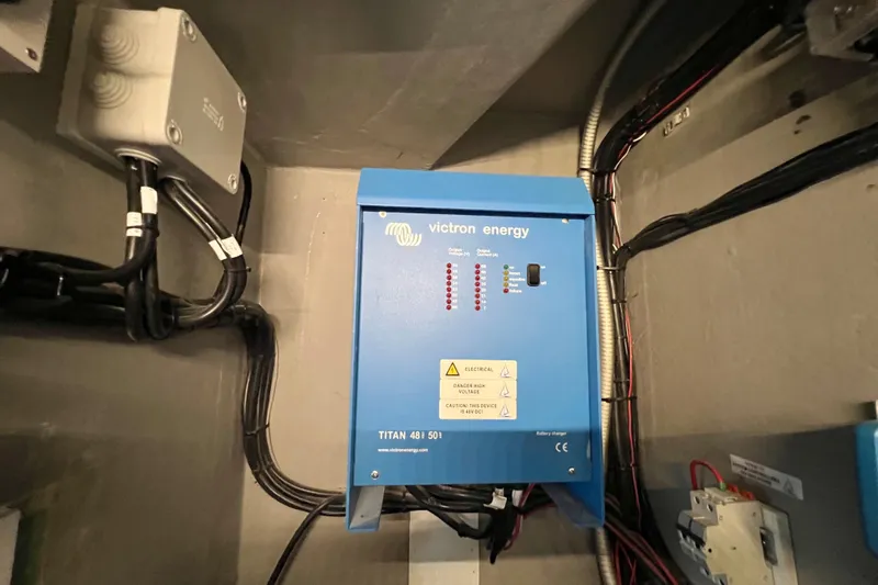 Ke'ala Yacht Photos Pics Blue Victron Energy device, model Titan 48/501, mounted on a wall with cables.