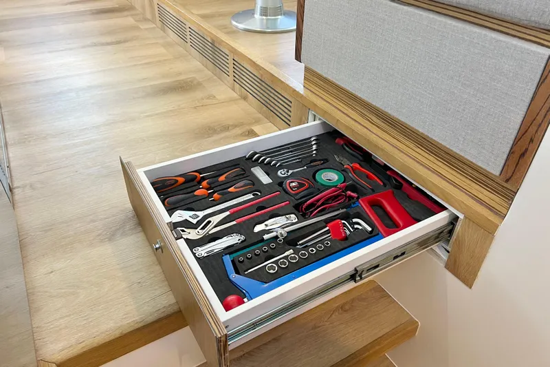 Ke'ala Yacht Photos Pics Organized tool drawer in wooden cabinet, featuring various hand tools and accessories.