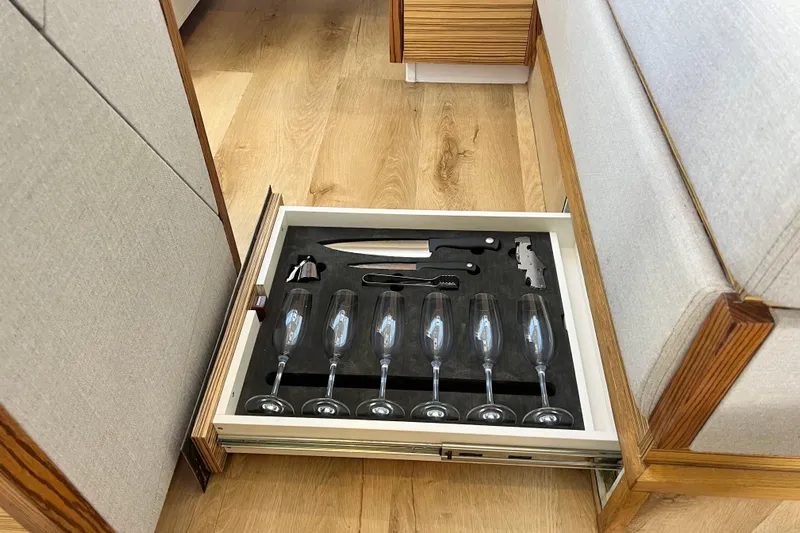 Ke'ala Yacht Photos Pics Drawer with glassware and utensils in Balance 482, 2021 model, on wooden floor.