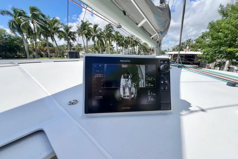 Ke'ala Yacht Photos Pics Sailing yacht Balance 482, 2021 model, with navigation display, docked near palm trees.