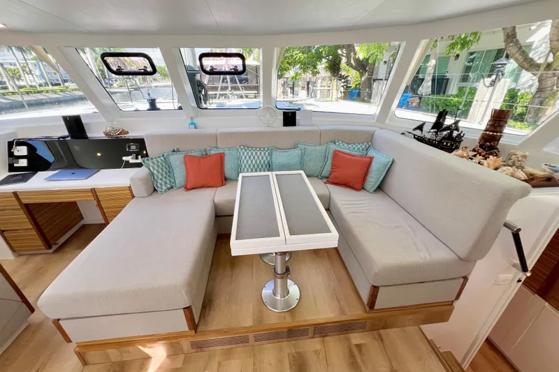 Ke'ala Yacht Photos Pics Modern yacht interior with cozy seating, colorful cushions, and large windows, Balance 482, 2021 model.