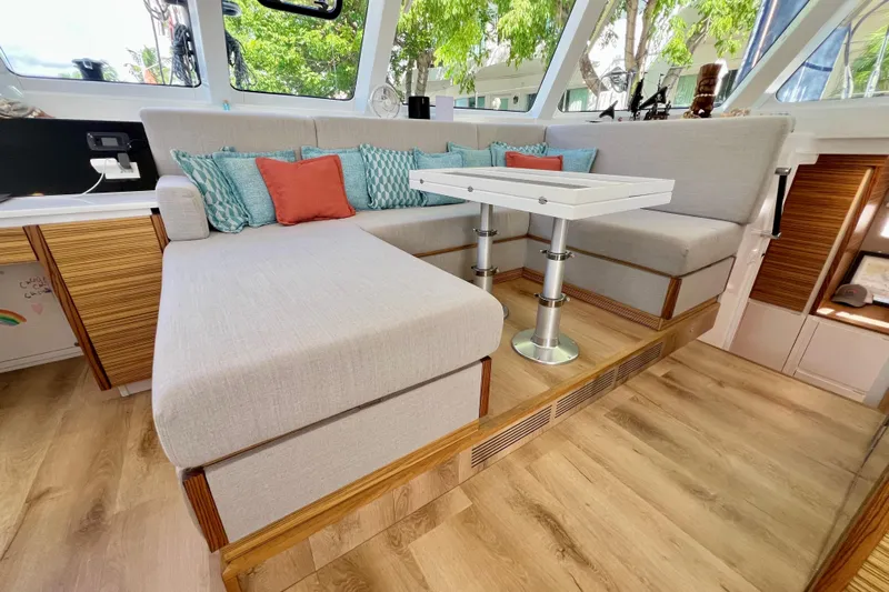 Ke'ala Yacht Photos Pics Modern interior of Balance 482 yacht, featuring cozy seating and elegant wooden flooring.