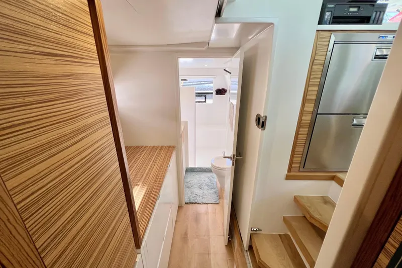 Ke'ala Yacht Photos Pics Modern yacht interior with wooden finishes, compact bathroom, and stainless steel appliances. Balance 482, 2021 model.