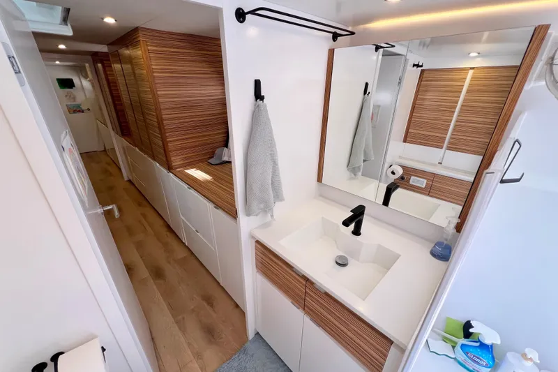 Ke'ala Yacht Photos Pics Modern bathroom interior in Balance 482, 2021 model, featuring wood accents and sleek fixtures.