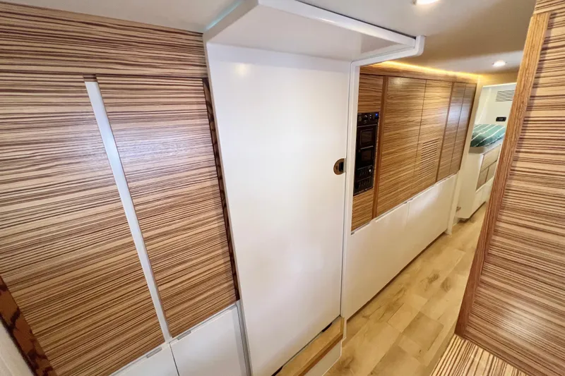 Ke'ala Yacht Photos Pics Modern interior of 2021 Balance 482 yacht with sleek wood paneling and ambient lighting.