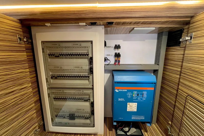 Ke'ala Yacht Photos Pics Electrical panel and inverter setup in a Balance 482, 2021 model, with wood paneling.