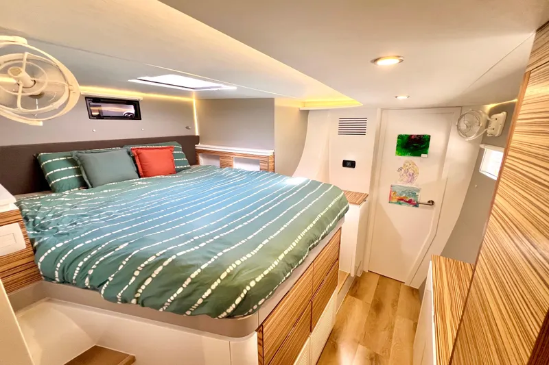 Ke'ala Yacht Photos Pics Modern bedroom interior in 2021 Balance 482 yacht with cozy bed and stylish wood accents.