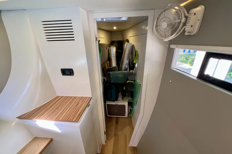Ke'ala Yacht Photos Pics Compact interior of 2021 Balance 482, featuring storage area with equipment and fan.