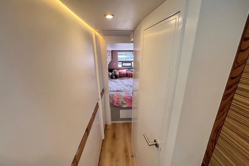 Ke'ala Yacht Photos Pics Narrow hallway leading to a cozy bedroom in a 2021 Balance 482 model.