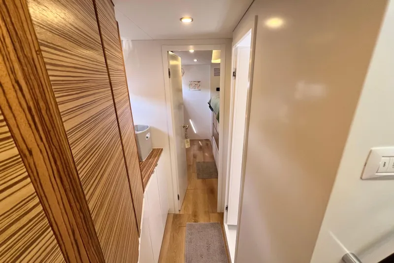 Ke'ala Yacht Photos Pics Modern yacht interior hallway with wood paneling, Balance 482 model, 2021.